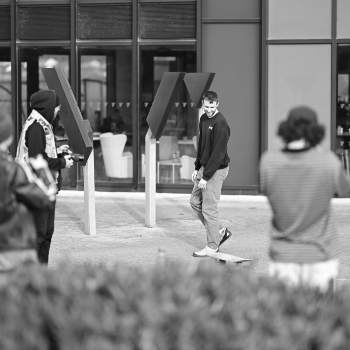 a group of students taking part in a workshop outside yr Egin 