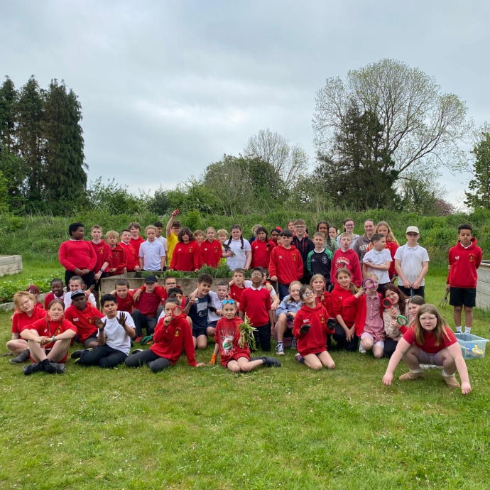 A school group shot outside Yr Egin's Community Garden celebrating Outdoor Learning Week 
