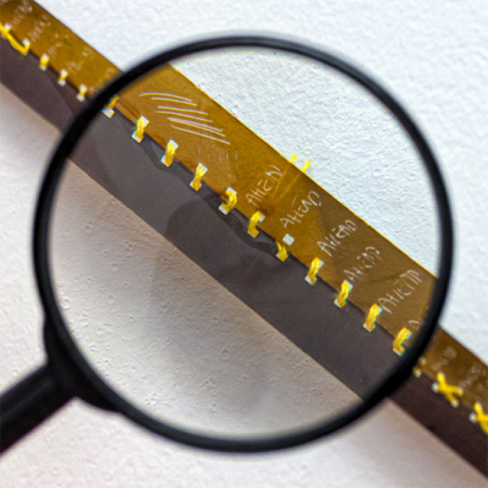 compass looking at gold metal with words