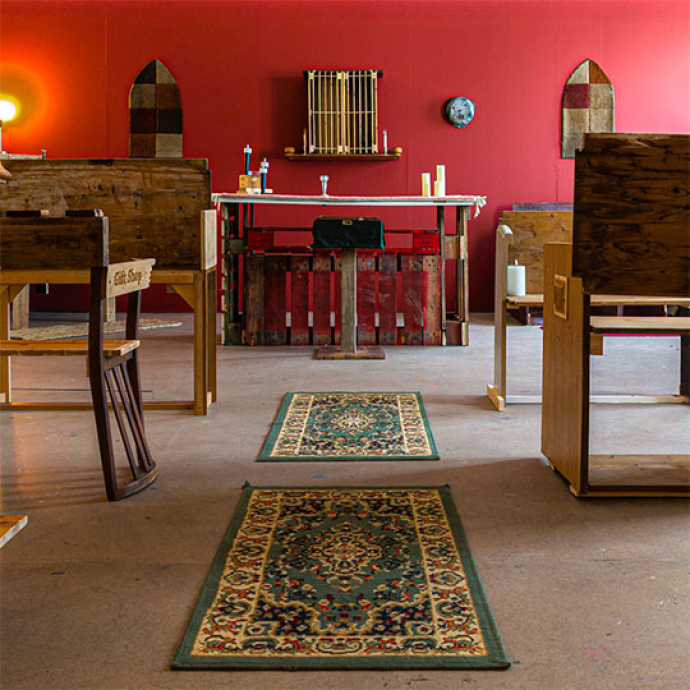 church with bench seats and a red wall