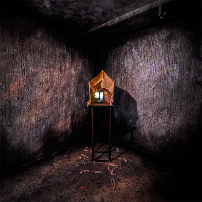 Dark gloomy walls with a small house 