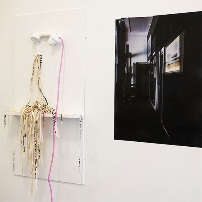 art and design of a phone and paper strings hanging from it