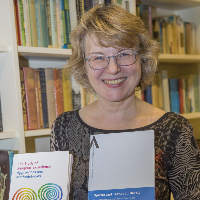 Professor Bettina Schmidt holding her textbooks