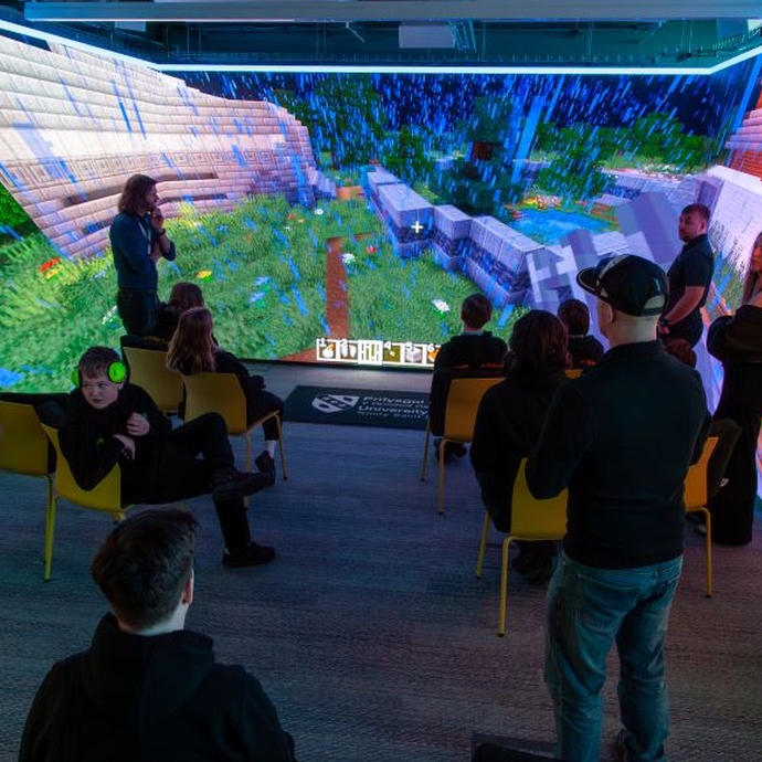Pupils in a multi-coloured immersive room.