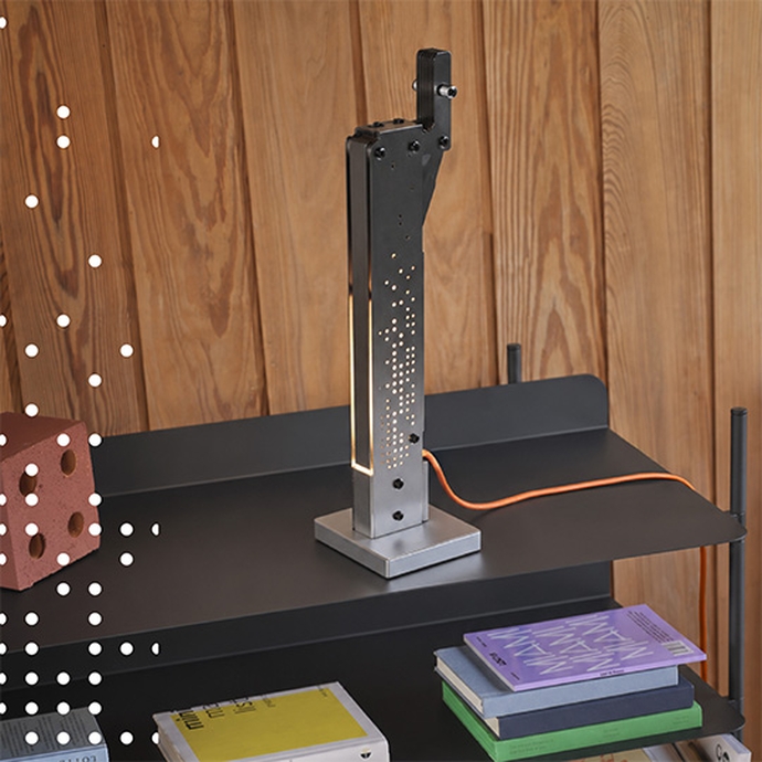 A desk lamp with a glowing light bulb, illuminating the workspace around it.